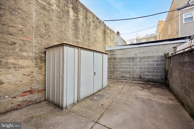 view of shed with fence