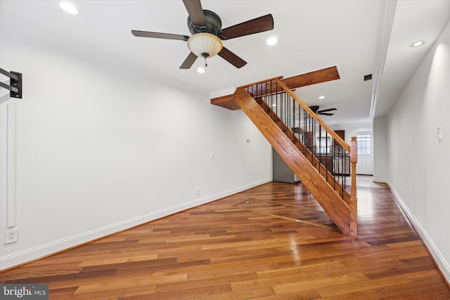 interior space featuring a ceiling fan, recessed lighting, baseboards, and wood finished floors