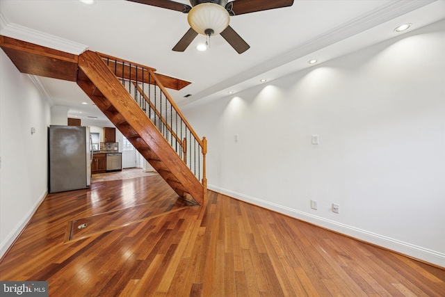 unfurnished living room with stairs, recessed lighting, hardwood / wood-style flooring, and baseboards