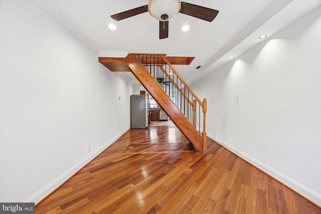 unfurnished living room featuring stairs, recessed lighting, baseboards, and hardwood / wood-style flooring