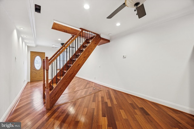 interior space featuring baseboards, a ceiling fan, wood-type flooring, crown molding, and recessed lighting