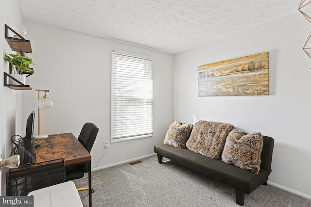 office area with baseboards, carpet flooring, visible vents, and a textured ceiling