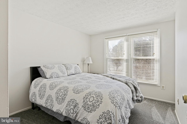 bedroom featuring carpet floors, a textured ceiling, and baseboards