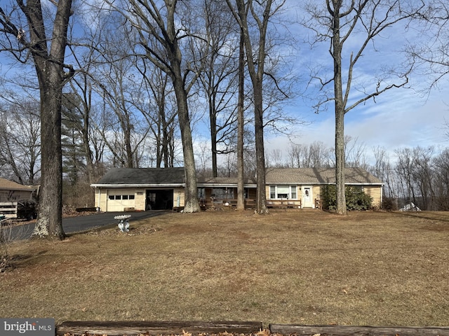 ranch-style home with driveway and an attached garage