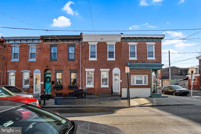 view of property featuring brick siding