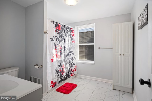 bathroom with baseboards, toilet, a shower with curtain, marble finish floor, and vanity