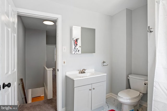 full bathroom with marble finish floor, baseboards, vanity, and toilet