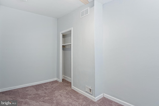 unfurnished bedroom featuring baseboards, visible vents, and carpet flooring