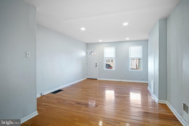 foyer featuring recessed lighting, wood-type flooring, visible vents, and baseboards