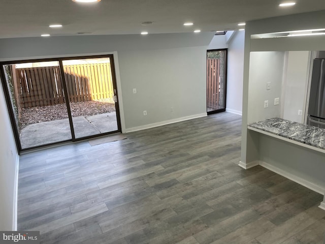 interior space with dark wood-style floors, baseboards, and recessed lighting