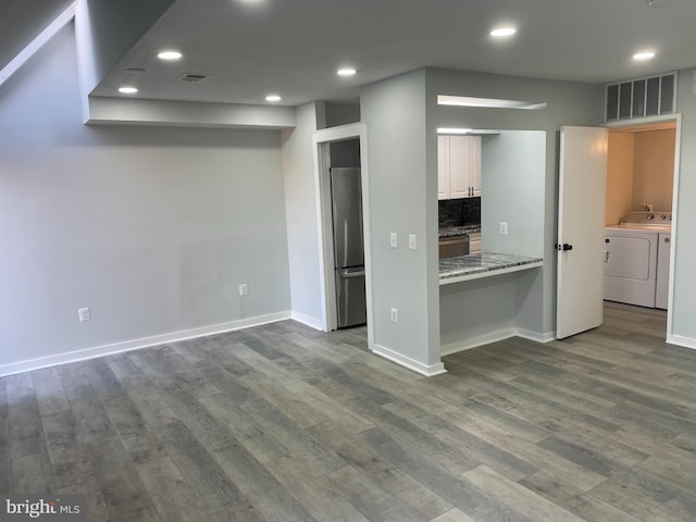 kitchen with stainless steel fridge, wood finished floors, visible vents, and white cabinetry