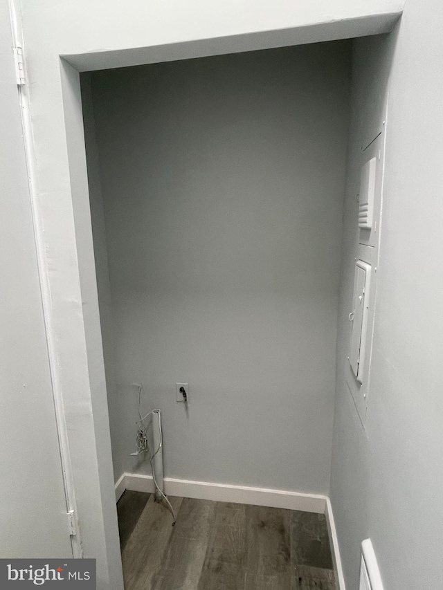 laundry area featuring baseboards, wood finished floors, and hookup for an electric dryer