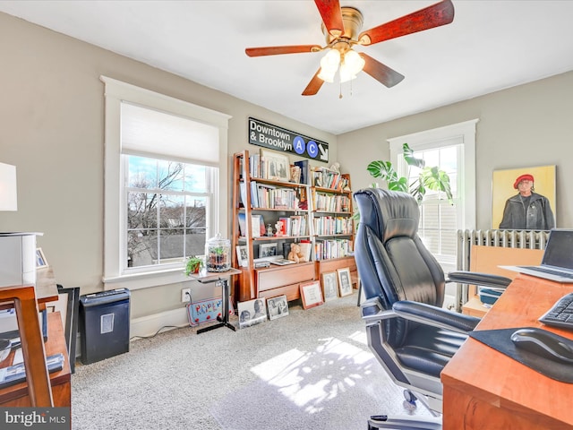 office featuring radiator, ceiling fan, and carpet flooring