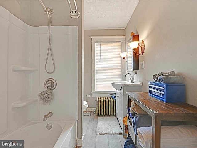 bathroom with shower / bathtub combination, toilet, radiator heating unit, vanity, and wood finished floors