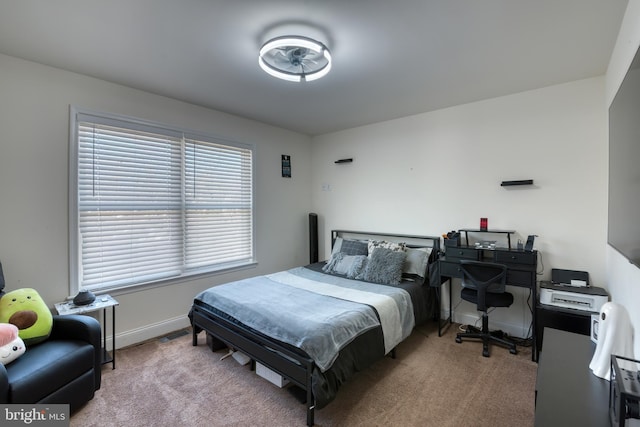 bedroom with carpet flooring and baseboards