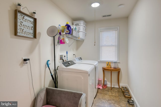 laundry room with baseboards, laundry area, visible vents, and washer and dryer