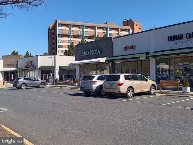 view of building exterior with uncovered parking