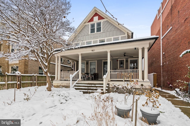 view of front of property featuring board and batten siding, covered porch, fence, and ceiling fan