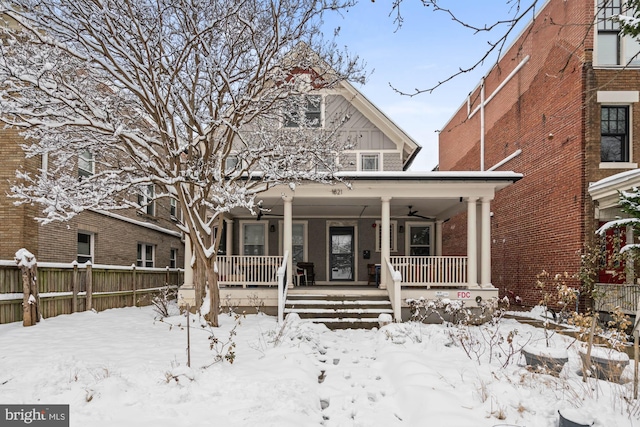 view of front of property featuring board and batten siding, covered porch, and fence