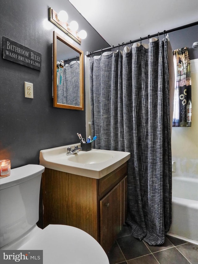 bathroom featuring shower / tub combo with curtain, vanity, toilet, and tile patterned floors