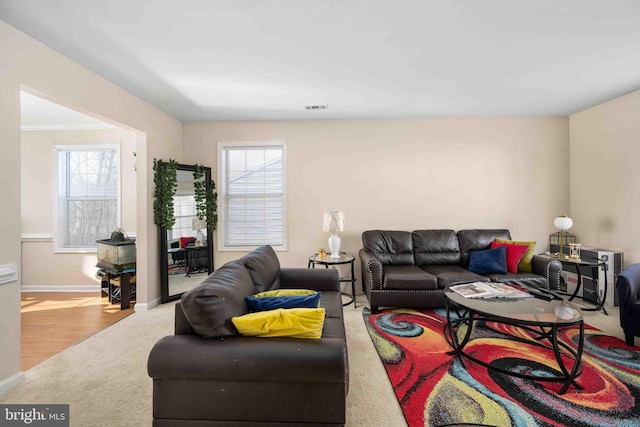 living room featuring baseboards and visible vents