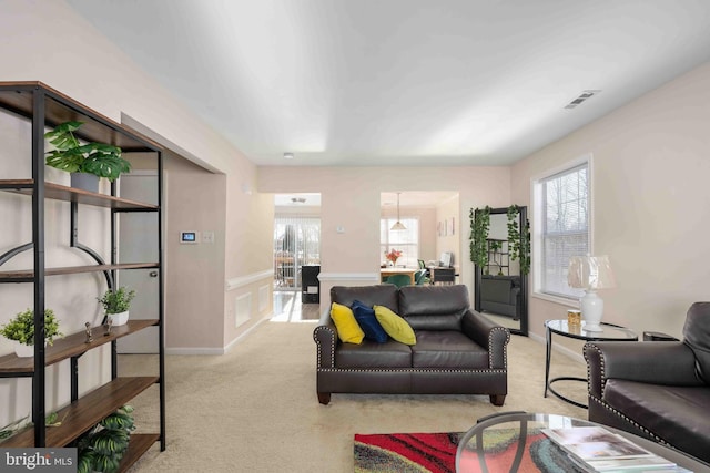 living room featuring carpet floors and visible vents