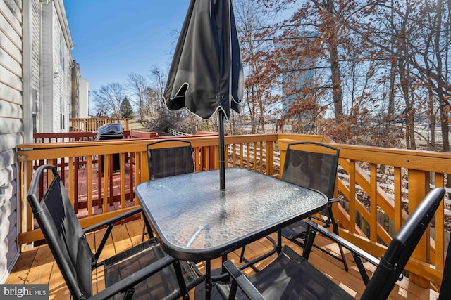 wooden terrace featuring outdoor dining area