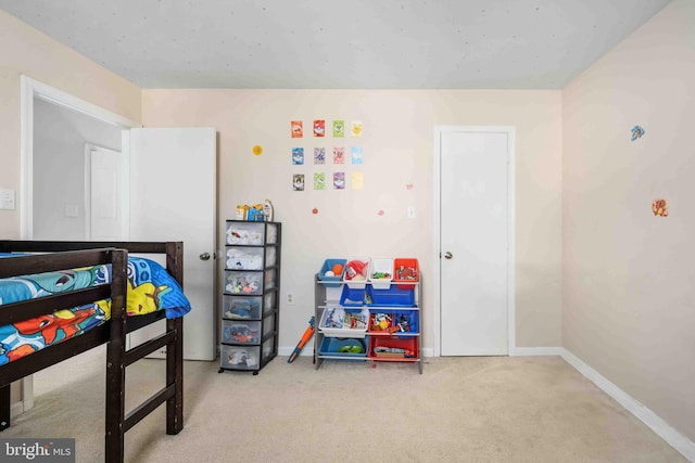 carpeted bedroom featuring baseboards