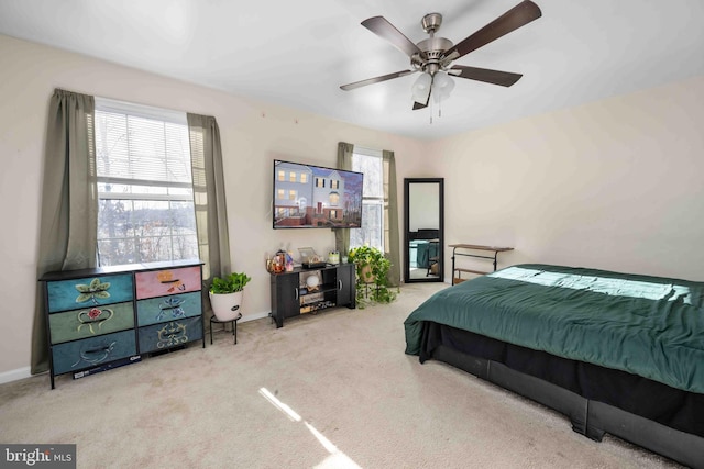 bedroom with a ceiling fan, carpet, and baseboards