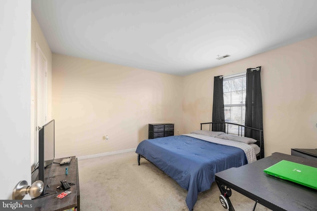 carpeted bedroom with visible vents and baseboards