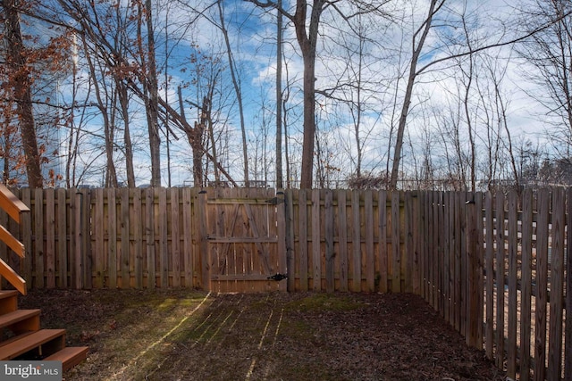 view of yard with a gate and a fenced backyard