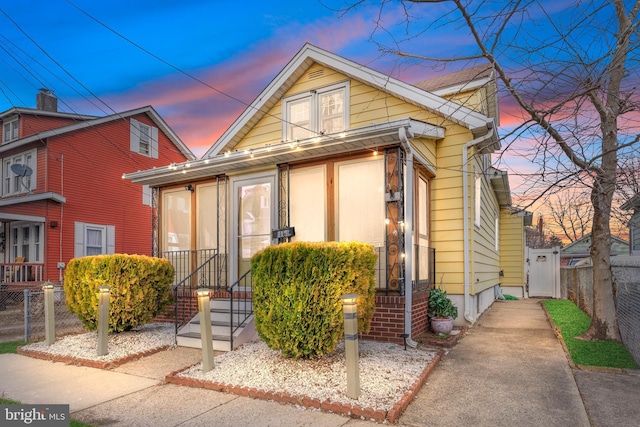 view of front of home featuring fence