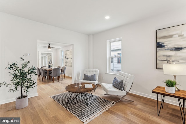 sitting room featuring light wood-type flooring, baseboards, and recessed lighting