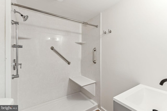 bathroom with a shower and a sink