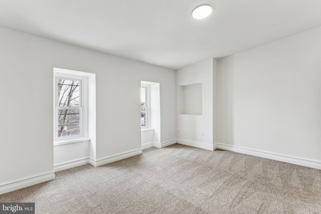 spare room with carpet flooring and baseboards