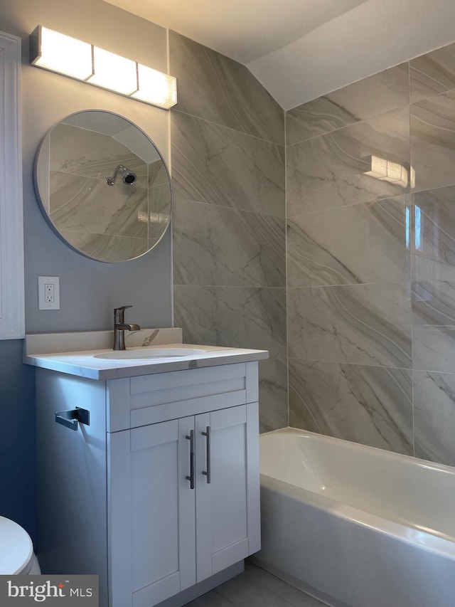 bathroom featuring vanity, toilet, and bathing tub / shower combination