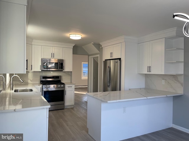 kitchen with appliances with stainless steel finishes, white cabinetry, a sink, and open shelves