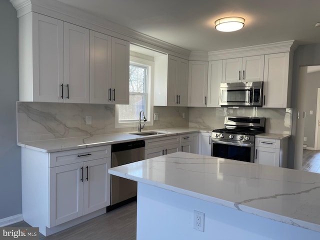 kitchen featuring white cabinetry, stainless steel appliances, and a sink