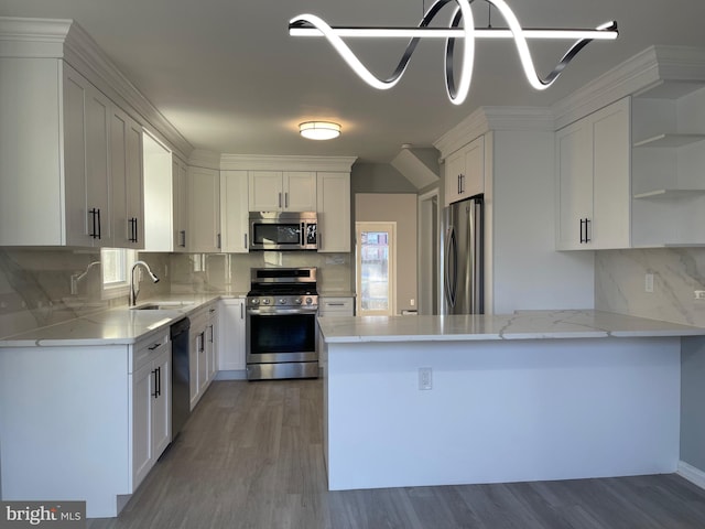 kitchen featuring appliances with stainless steel finishes, white cabinets, a sink, and open shelves