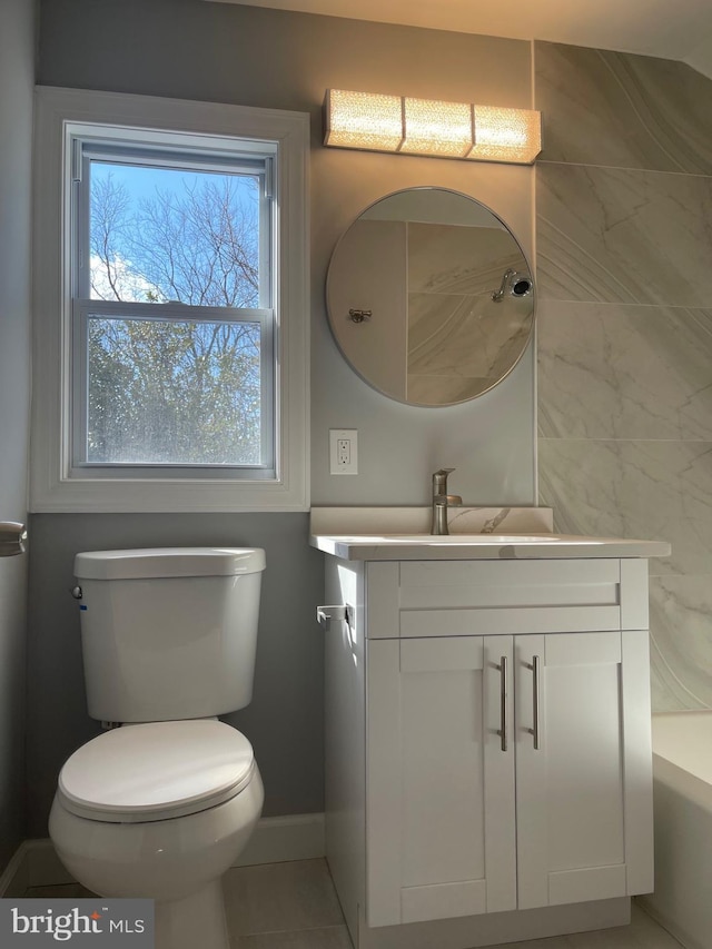 full bathroom featuring toilet, baseboards, and vanity