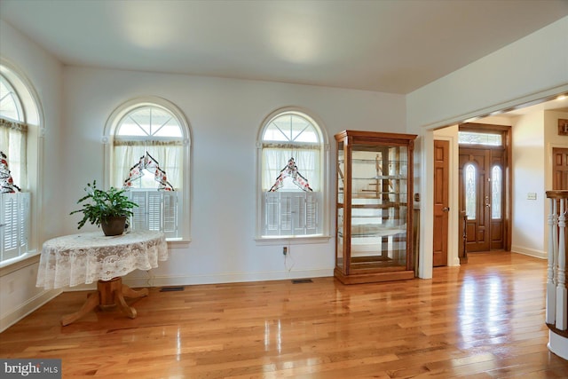 entrance foyer featuring light wood finished floors, visible vents, and baseboards