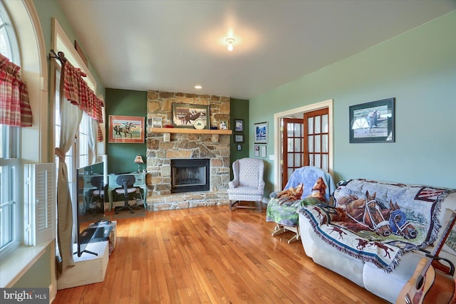 living room with a fireplace and wood finished floors