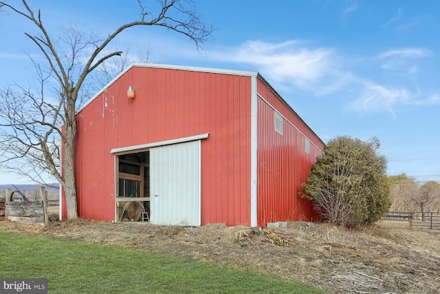 view of pole building featuring fence