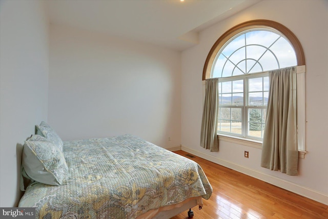 bedroom with wood finished floors and baseboards