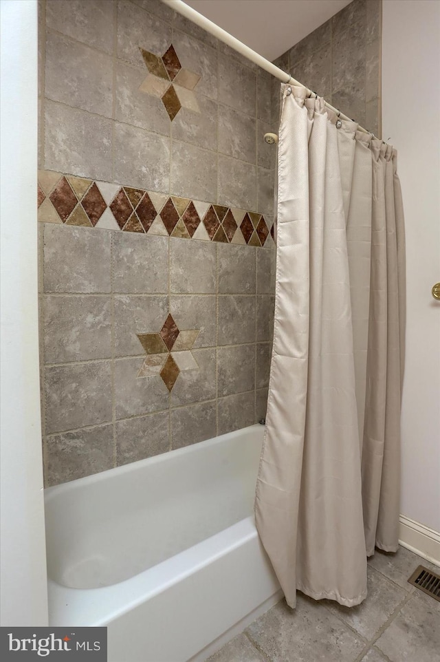 bathroom with shower / bath combination with curtain and visible vents