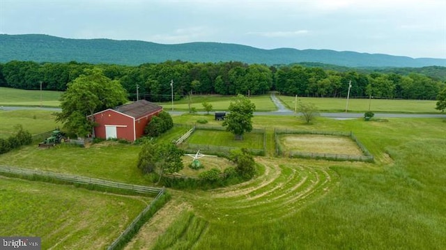 aerial view with a mountain view, a view of trees, and a rural view