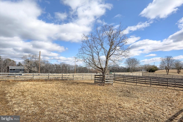 view of yard featuring a rural view and fence