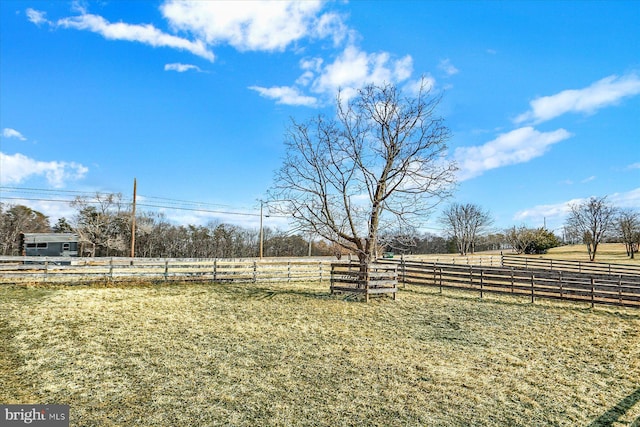 view of yard featuring fence and a rural view