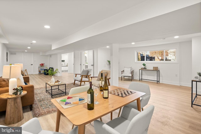 living area with light wood finished floors, baseboards, and recessed lighting