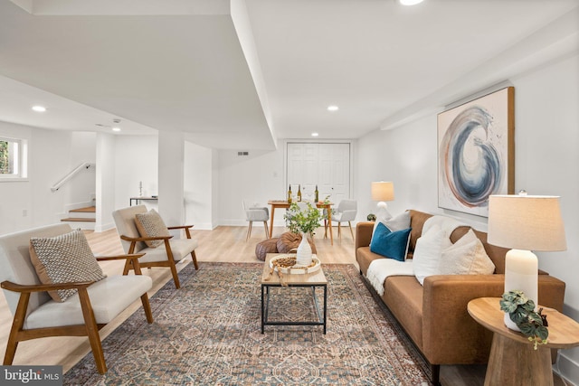 living room with stairs, baseboards, wood finished floors, and recessed lighting